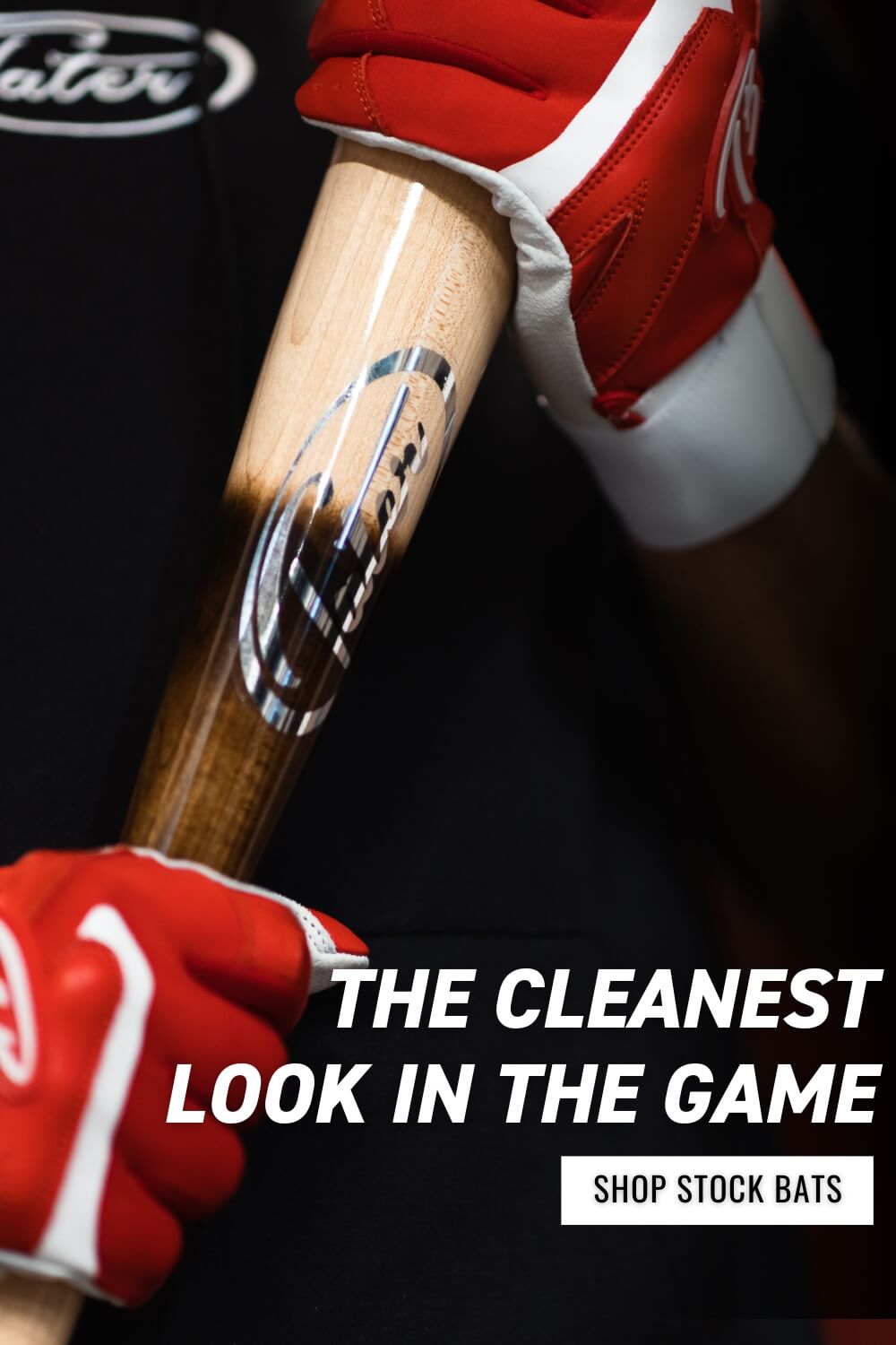 A close-up of a baseball player holding the original pine tar flame bat with a clear focus on the silver Tater logo at the neck of the bat.