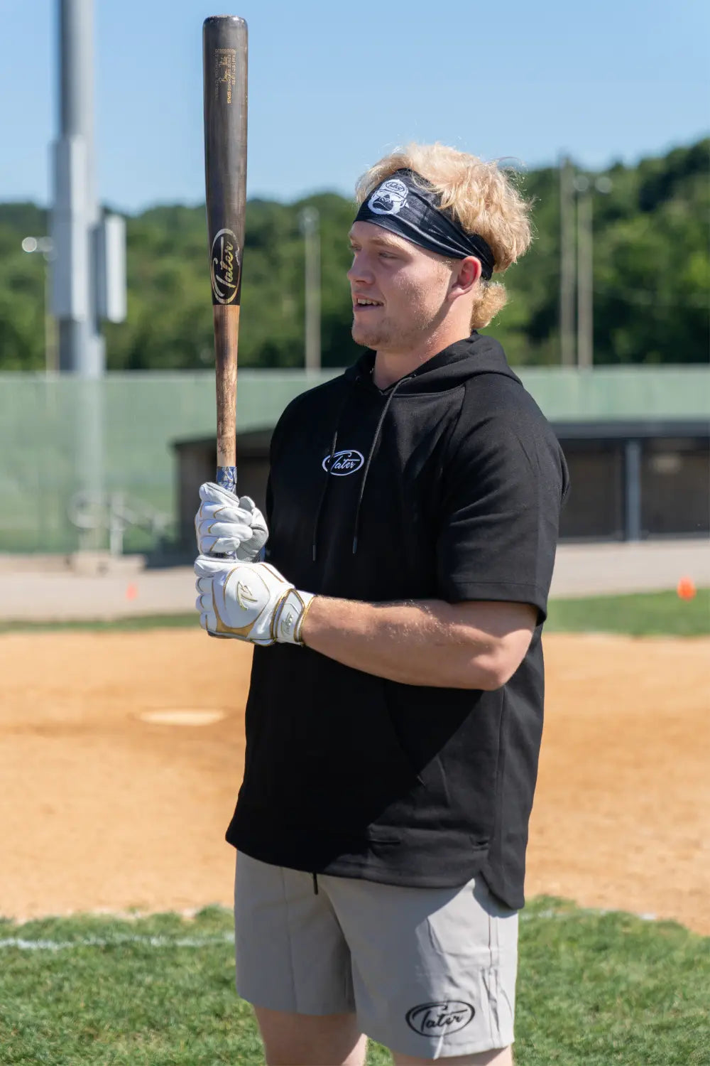 Benjamin Huber holding a balanced birch wooden bat.