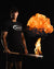 Baseball player holding grey maple wood bat that has a ball of fire errupting from the barrel