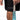 The image features a close-up view of a person wearing black athletic shorts with the word "TATER" printed on them, indicating they are part of a sports or athletic wear collection. The individual is also holding a light blue baseball bat, which is partially visible in the shot. The focus on the branded shorts and the bat suggests that the image might be used for promotional purposes to highlight the brand's association with baseball and athletic gear.