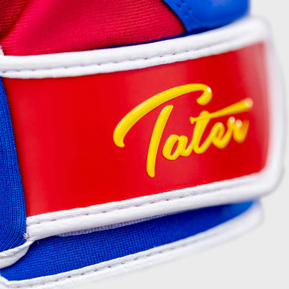 Ultra close-up of the adjustable strap on Tater Baseball batting gloves, featuring the elegant gold-scripted 'Tater' logo against a striking red background, emphasizing the brand's attention to detail and quality.