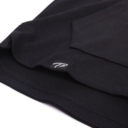 Close-up of a black FUNDAMENTALS fitted short-sleeve hoodie with a subtle white 'TB' logo from Tater Baseball, highlighting the brand's minimalist design.