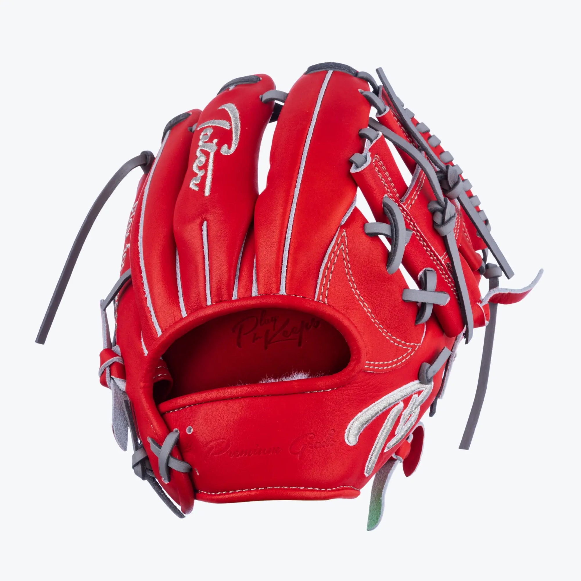 Unleash your fielding potential with Tater Baseball's vibrant red professional infield training glove. This 9.5-inch glove is meticulously crafted with premium materials, featuring gray lacing and signature branding. Perfect for athletes focusing on agility and precision in the infield.