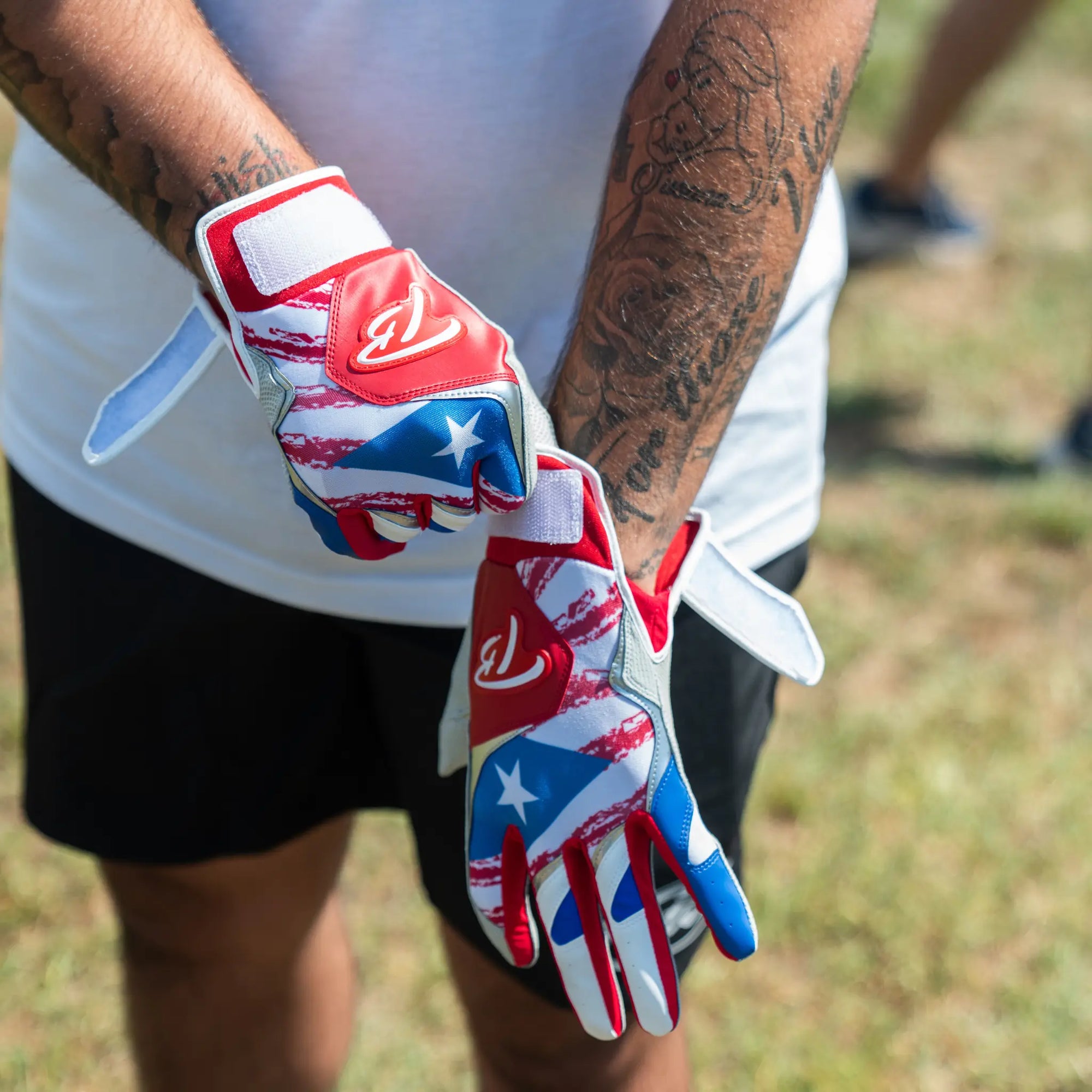 High-performance Tater baseball batting gloves featuring a Puerto Rico-inspired design with vivid red, white, and blue colors, accented with a single star, and the distinctive 'TB' logo for a touch of patriotic flair.