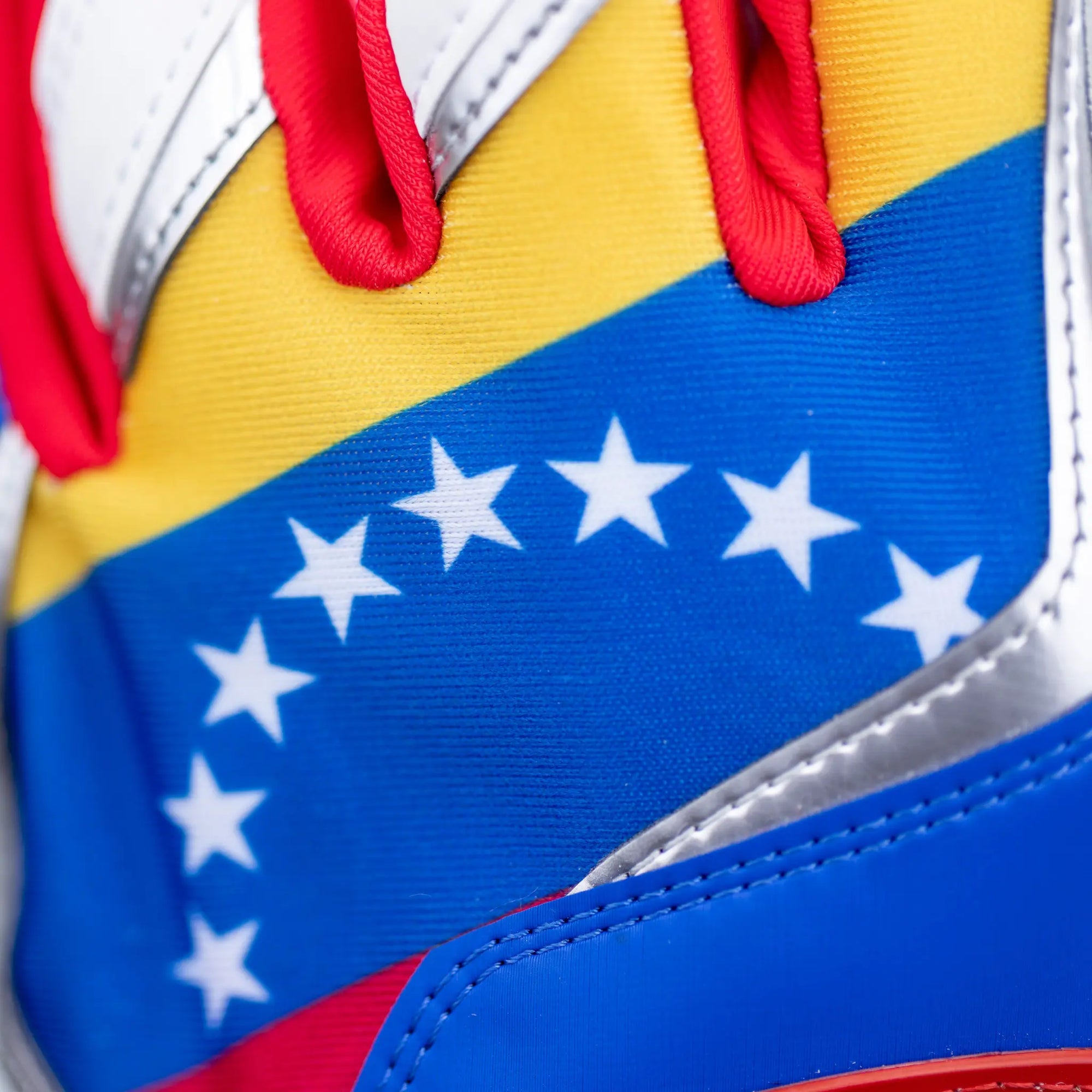 Adult-sized Tater Baseball batting gloves featuring a vibrant Venezuelan flag-inspired design with a blue, yellow, and red colorway, enhanced with a prominent Tater logo on the adjustable wrist strap, and a stylized 'TB' emblem on the back for a patriotic and performance-oriented look.