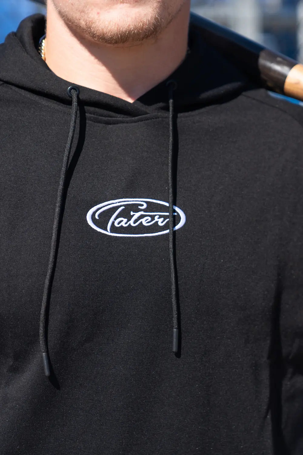 Closeup of Benjamin Huber wearing hoode with an amphasis on the embroidered logo.